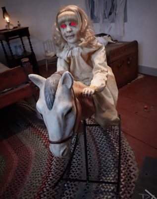 creepy doll on rocking horse