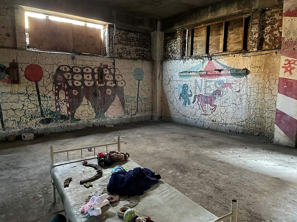 Pictured: Dilapidated murals blanket the walls of Pennhurst Asylum's former nursery room