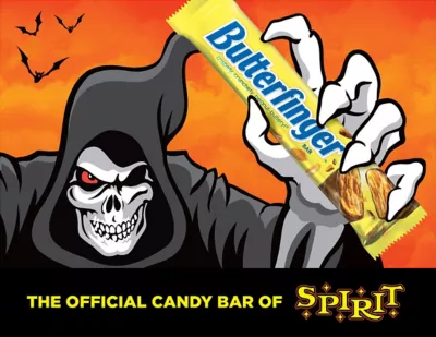 Jack the Reaper, Spirit Halloween's mascot, holding a Butterfinger candy bar against orange sunset background with bats flying, branded as 'The Official Candy Bar of Spirit'